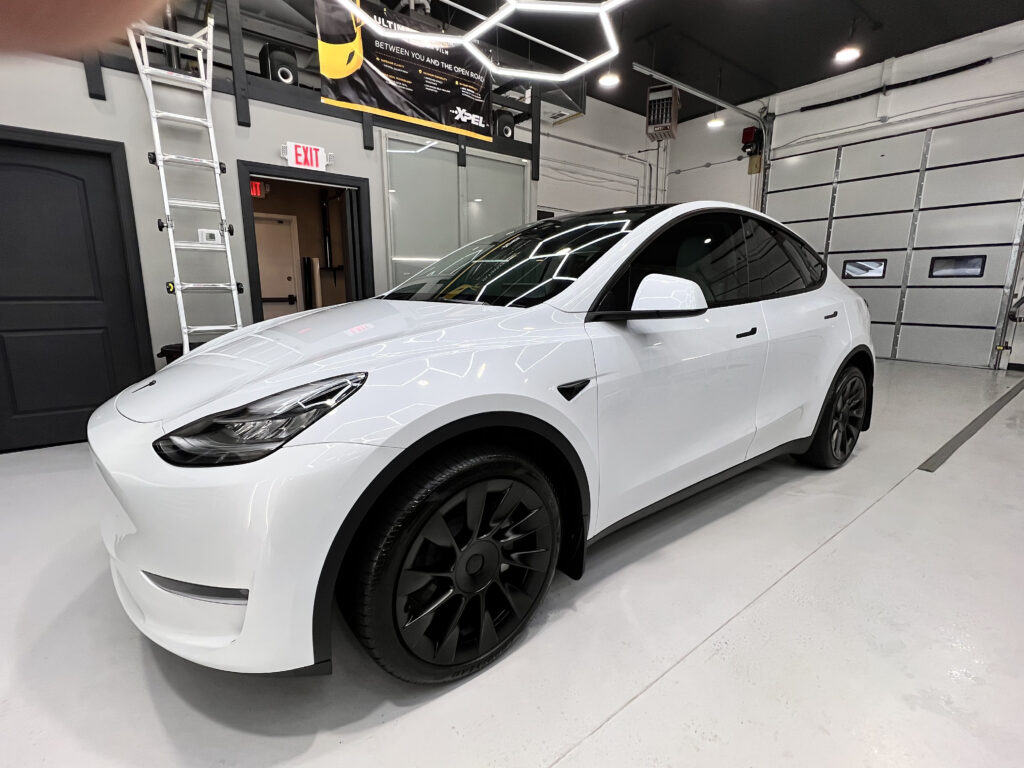 White Tesla driver side view